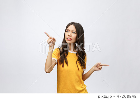 young attractive asian woman who points to the finger with unhappy emotion. young attractive asian woman who points to the finger with unhappy emotion. 47268848