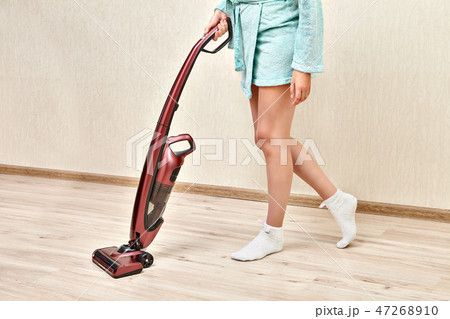 Woman with handheld vacuum cleaner in hands. Woman with handheld vacuum cleaner in hands. 47268910