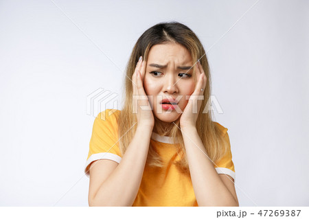 Portrait of sad crying pensive mad crazy asian woman. Closeup young asian woman isolated on white Portrait of sad crying pensive mad crazy asian woman. Closeup young asian woman isolated on white 47269387