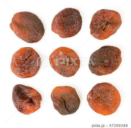 Set of dark dried apricots on a white. The form of 47269388