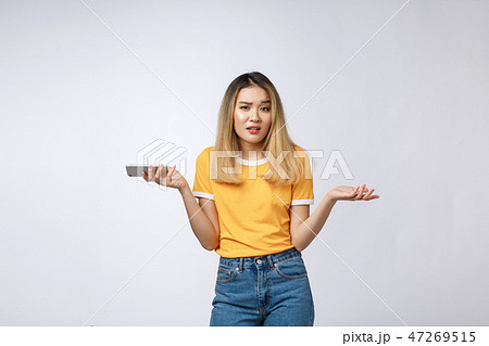 Unhappy Asian girl on the phone , Angry Asian woman talking phone with her boyfriend, isolated on 47269515