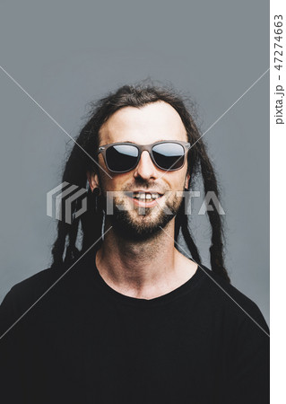 Portrait of a young smiling man with dreadlocks 47274663