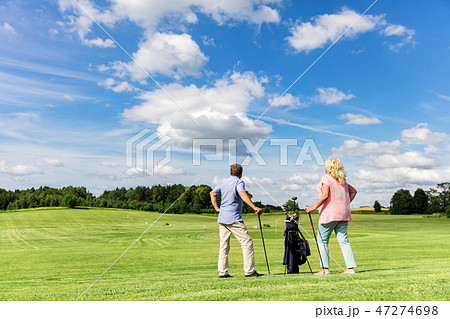 Active senior couple playing golf on a course. 47274698