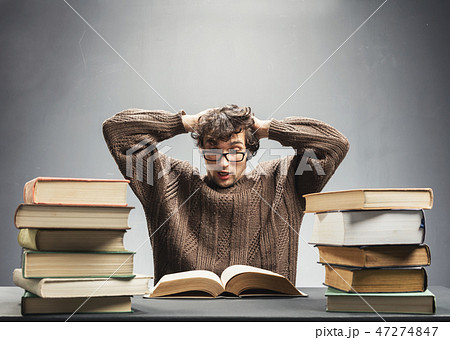 Terrified student reading a book. 47274847