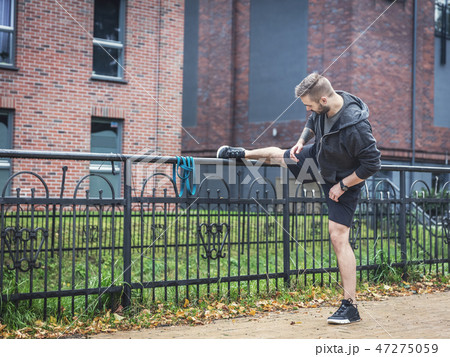 Outdoor stretching. Healthy exercising habits. 47275059