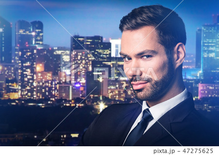 Handsome man on city at night background. 47275625