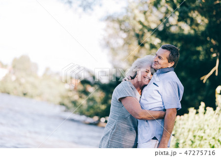 Senior woman hugging her husband Senior woman hugging her husband 47275716