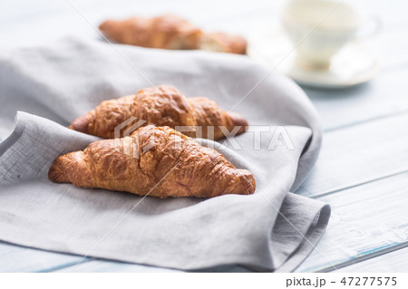 Fresh buttery croissants on kitchen napkin. Fresh buttery croissants on kitchen napkin. 47277575