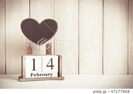 Valentines Day card with wooden block calendar on white wooden background witn copy space for text. Valentines Day card with wooden block calendar on white wooden background witn copy space for text. 47277608
