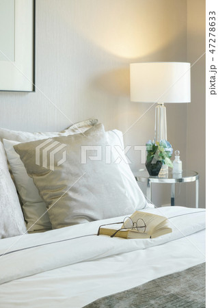 Glasses and book on bed in modern interior bedroom 47278633