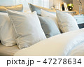 Closeup roll of pillows setting on comfortable bed 47278634
