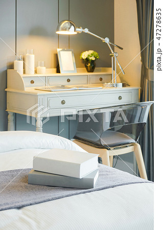 Books on bed with working table in background Books on bed with working table in background 47278635