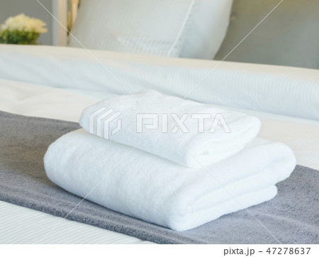 White towels on bed in modern bedroom interior White towels on bed in modern bedroom interior 47278637
