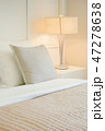 Beige pillow on comfy bed in modern bedroom 47278638