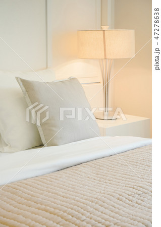 Beige pillow on comfy bed in modern bedroom Beige pillow on comfy bed in modern bedroom 47278638