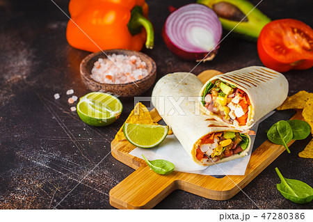 Burritos wraps with chicken, beans, corn, tomatoes 47280386