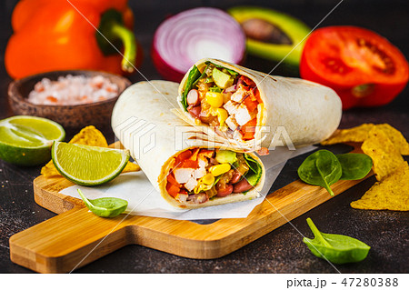 Burritos wraps with chicken, beans, corn, tomatoes 47280388