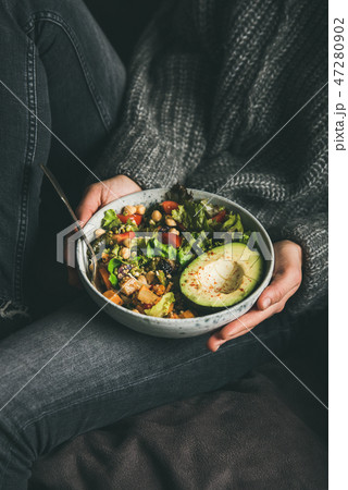 Woman holding bowl with fresh salad, avocado Woman holding bowl with fresh salad, avocado 47280902