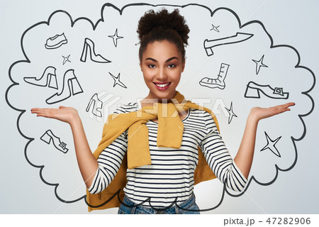 Young woman studio isolated in white hands aside presenting look 47282906