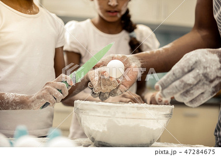 Close up of daughters and father having their hands in flour 47284675