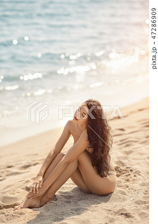 Nude beautiful woman on the nudist beach