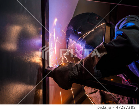 Welder Worker Performs Jump Welding. Worker Welder Performs Arc-Welding Process of Metal Structures 47287285