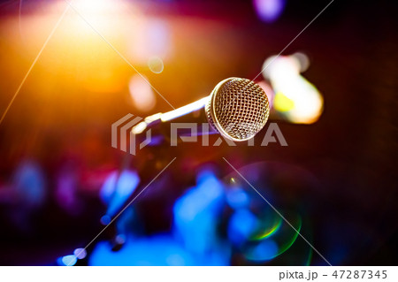 Microphone on stage against a background\ 47287345