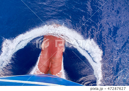 View from top on bulbous bow of ship underway. 47287627