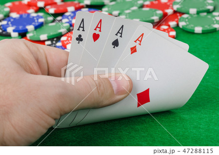 Hand with playing cards in casino 47288115