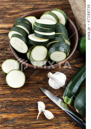 zucchini sliced and whole zucchini lying zucchini sliced and whole zucchini lying 47288736