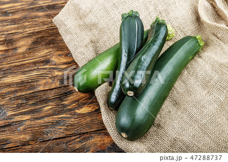 fresh zucchini on a natural brown wooden fresh zucchini on a natural brown wooden 47288737
