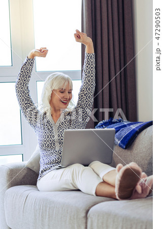 Happy good looking woman feeling absolutely relaxed Happy good looking woman feeling absolutely relaxed 47290503