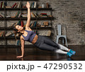 Fitness woman doing side plank during yoga workout at home 47290532