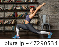 Young fitness woman doing front lunge during yoga exercise 47290534