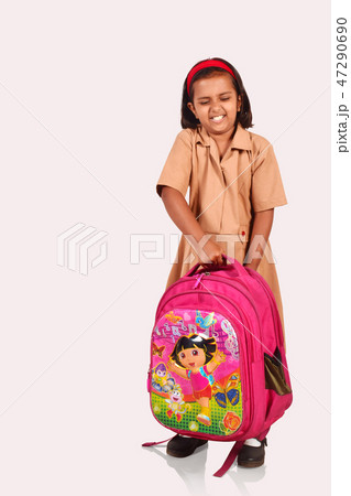 Little girl in school uniform picking a school bag Little girl in school uniform picking a school bag 47290690