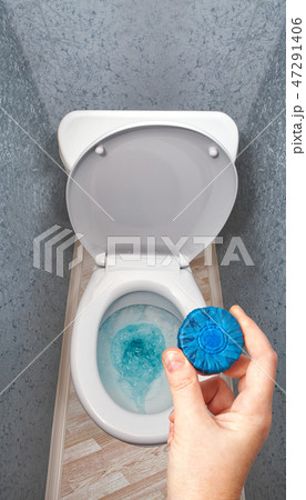 solid detergent is put in toilet bowl tank. solid detergent is put in toilet bowl tank. 47291406