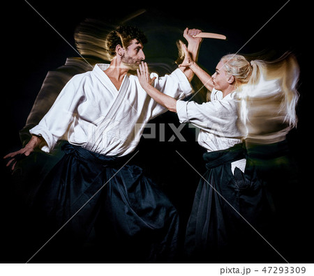 Aikido budokas man and woman isolated black background 47293309