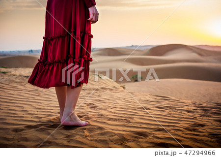 Woman walking in the desert 47294966