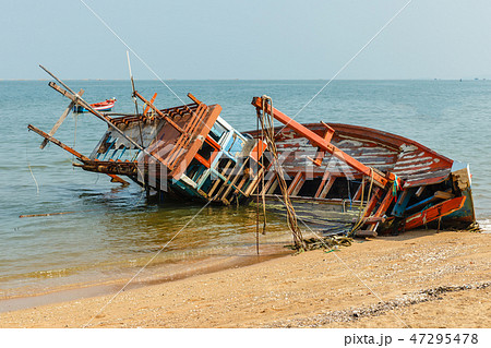 a broken fishing ship lies on its side a broken fishing ship lies on its side 47295478