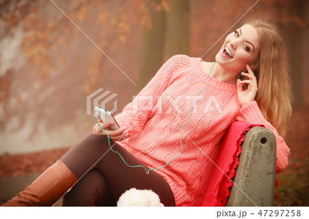 girl listening to music in autumn park girl listening to music in autumn park 47297258