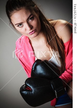 Sport boxer woman in black gloves boxing Sport boxer woman in black gloves boxing 47297441