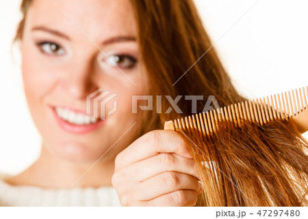 Woman combing and pulls hair. Woman combing and pulls hair. 47297480