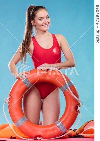 Lifeguard woman on duty with ring buoy lifebuoy. 47298048