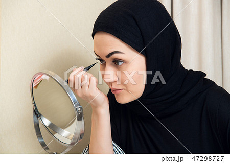 close-up portrait of charming Muslim woman wearing makeup. do face close-up portrait of charming Muslim woman wearing makeup. do face 47298727