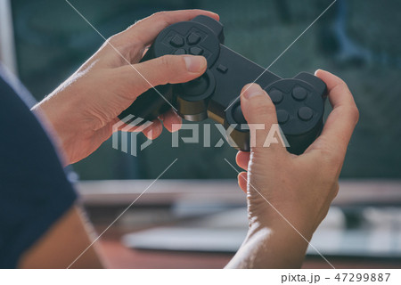 Woman plays video game using the gamepad 47299887