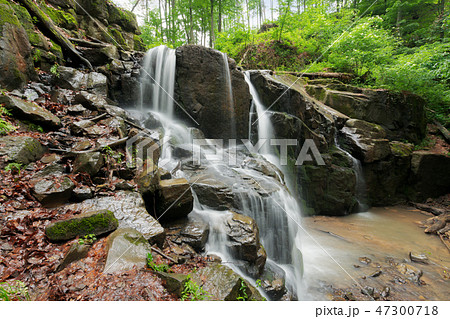 beautiful waterfall among the huge rocks in forest beautiful waterfall among the huge rocks in forest 47300718
