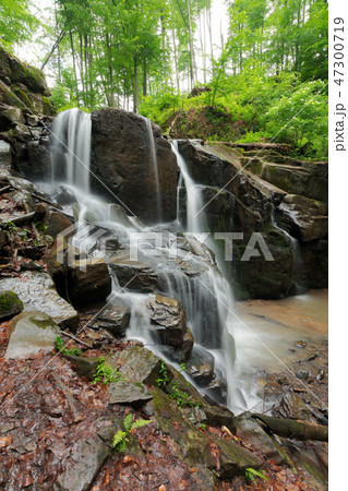 beautiful waterfall among the huge rocks in forest beautiful waterfall among the huge rocks in forest 47300719