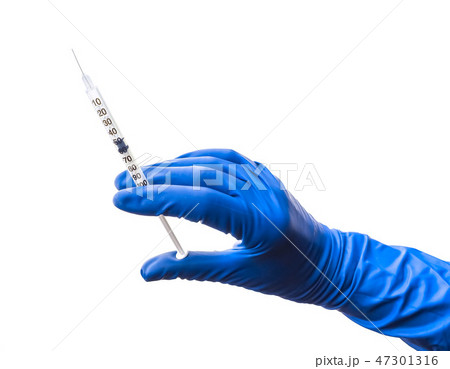 Doctor's hand in blue medical glove holding open syringe with medical solution isolated white Doctor's hand in blue medical glove holding open syringe with medical solution isolated white 47301316