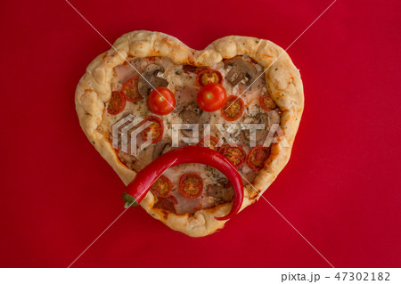 Pizza heart shaped on red Pizza heart shaped on red 47302182
