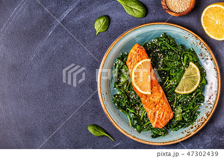 Grilled salmon with spinach. Grilled salmon with spinach. 47302439